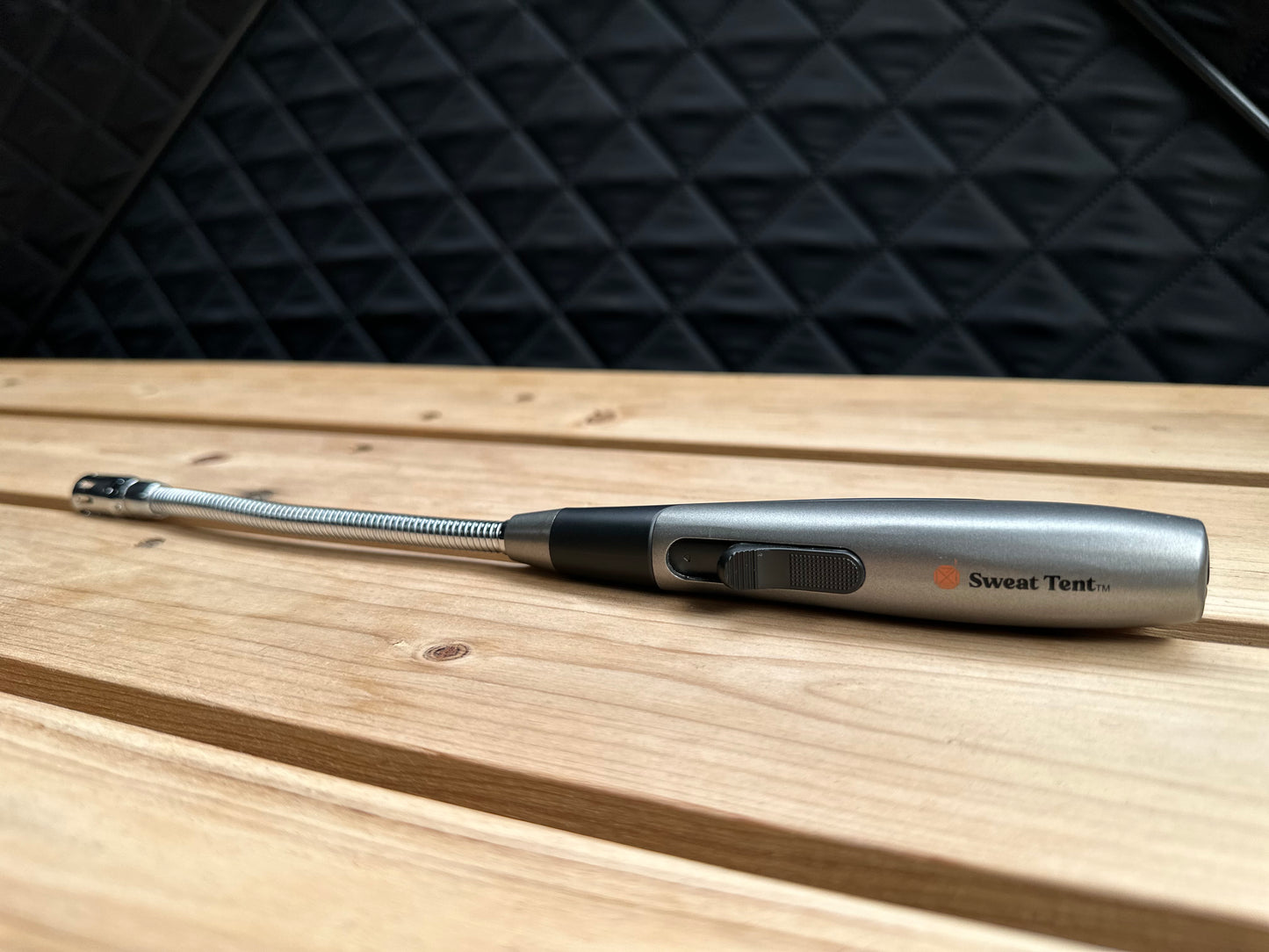 a butane lighter sitting on a cedar bench