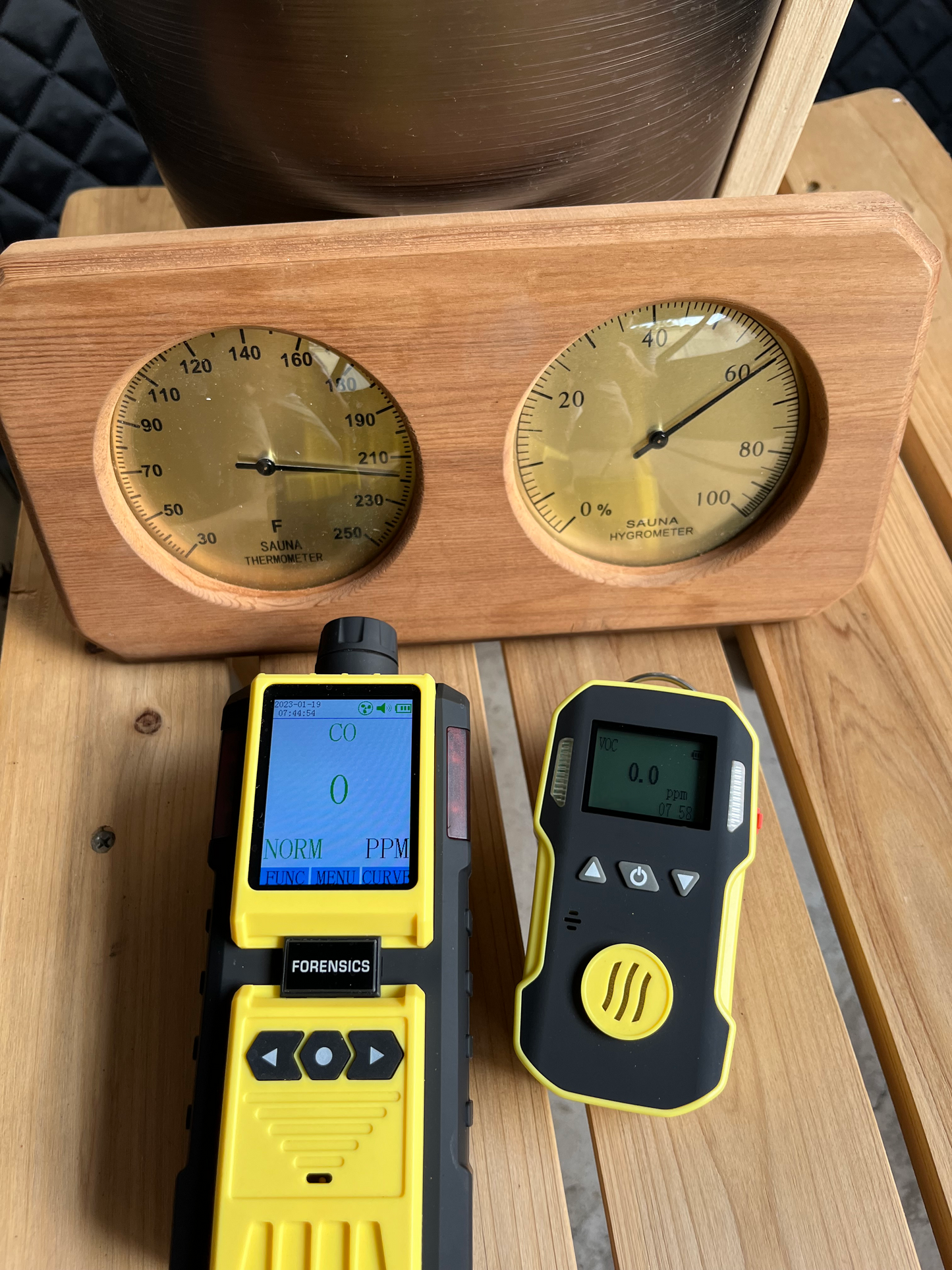 Two VOC meters showing that Sweat Tent gives off zero VOCs at 200 degrees